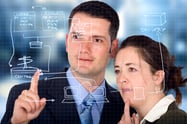 business partners analyzing a database structure in an office